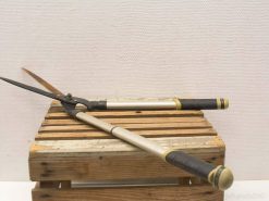 Premium garden shears on a rustic wooden crate, perfect for pruning and shaping plants.