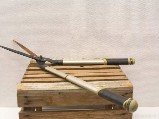 Premium garden shears on a rustic wooden crate, perfect for pruning and shaping plants.