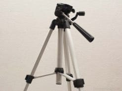 High-quality white and black photography tripod with adjustable head for stability and versatility.