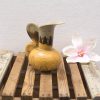 Charming vintage yellow ceramic pitcher with faux magnolia, perfect for stylish home decor.