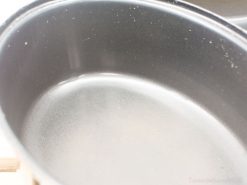 Sleek oval cooking pot with shiny black finish, perfect for all cooking methods.