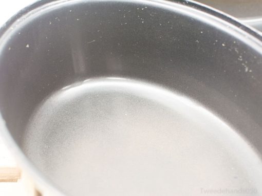 Sleek oval cooking pot with shiny black finish, perfect for all cooking methods.