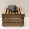 Rustic wooden crate with intricately designed decorative duck sculpture for vintage-style decor.