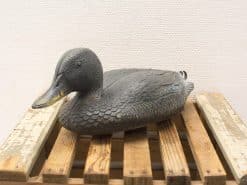 Vintage duck decor, authentic hunting decoy in dark green and black for rustic charm.