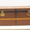 Vintage brown trunk with leather accents and brass clasps, perfect for storage or decor.