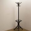 Elegant vintage coat rack with curved hooks, perfect for home or office decor.
