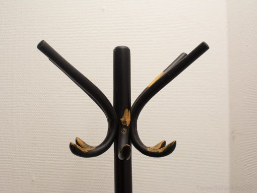 Sleek black vintage coat rack combines minimalist design with charming signs of use.