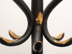 Elegant vintage coat rack with charming wear, showcasing timeless design and character.