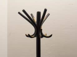 Sleek black vintage coat rack with curved hooks, perfect for modern home entryways.