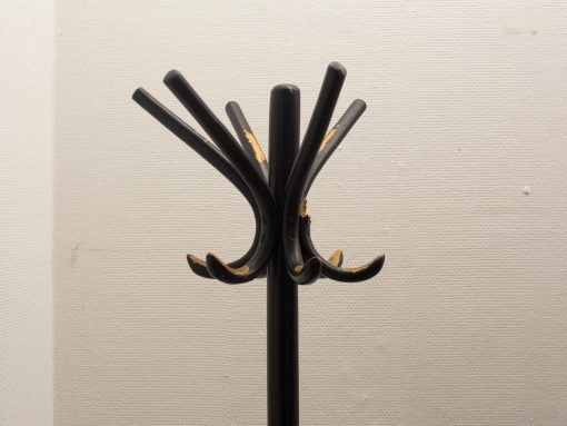 Sleek black vintage coat rack with curved hooks, perfect for modern home entryways.
