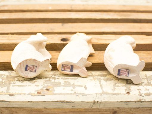 Set of three rustic wooden fish carvings with natural textures for charming home decor.