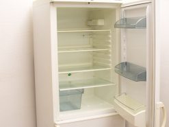 Modern white refrigerator with adjustable shelves and organized storage for food and beverages.