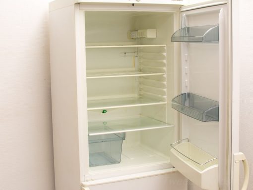 Modern white refrigerator with adjustable shelves and organized storage for food and beverages.