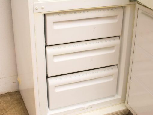 Compact white refrigerator with three pull-out freezer drawers, perfect for organized frozen storage.