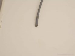 Close-up of a gray wire, ideal for vintage electrical projects and unique decor.