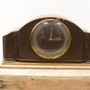 Elegant vintage wooden mantel clock with gilded accents and intricate floral carvings.