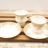 Elegant vintage floral tea set with gold trim, perfect for afternoon tea or decor.