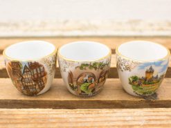 Charming vintage china cups with cultural designs and gold accents, perfect for collectors.