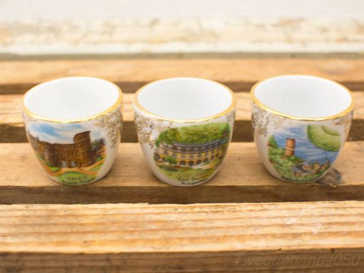 Charming vintage decorative cups featuring hand-painted scenes of iconic landmarks and nature.