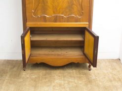 Elegant vintage cabinet with intricate wood carvings and open shelves for stylish storage.