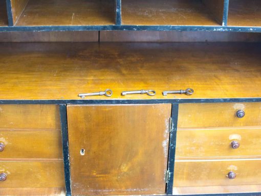 Vintage wooden cabinet with antique keys and elegant design, perfect for adding character to any space.