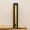 Vintage dual-scale thermometer in yellow and black, perfect for retro home decor enthusiasts.