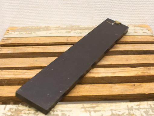 Vintage wooden plank with metal detail, showcasing rustic charm and craftsmanship. Ideal for decor.