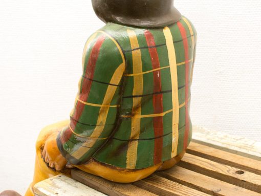 Colorful ceramic man figure with plaid design, celebrating rustic folk art charm.