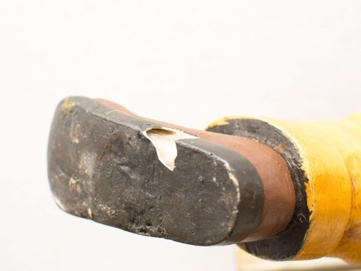 Vintage shoe sole displaying unique character and history through texture and wear.