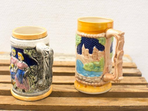 Elegant vintage ceramic mugs featuring intricate designs of tradition and nature. Perfect for collectors!