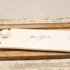 Elegant porcelain platter for serving foie gras with gold accents and rustic charm.