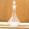 Elegant glass decanter with a detailed stopper, perfect for serving wine or water.