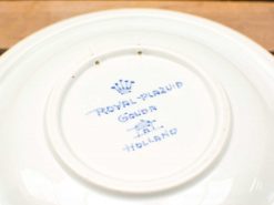 Royal Plazuid Gouda ceramic plate with blue inscription and crown, perfect for decor or dining.