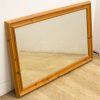 Elegant light wood mirror with a rustic frame, ideal for any interior style.