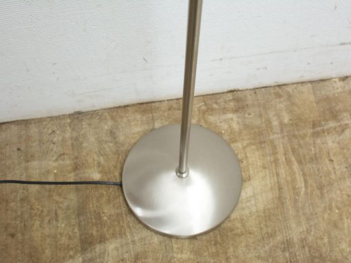 Sleek stainless steel floor lamp with elegant minimalist design and warm ambiance. Perfect for any decor.