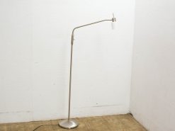 Sleek brushed metal floor lamp with minimalist design and soft white shade for modern interiors.
