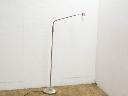 Sleek brushed metal floor lamp with minimalist design and soft white shade for modern interiors.