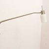 Sleek modern floor lamp with curved stainless steel arm and frosted glass shade for elegant lighting.