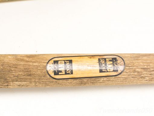 Vintage wooden baseball bat with natural grain and quality branding, ideal for collectors.