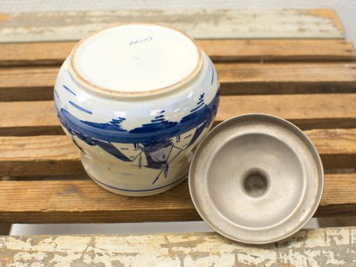 Hand-painted ceramic pot with nautical design and polished metal lid, ideal for rustic décor.