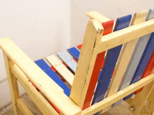 Colorful rustic bench, perfect for indoor or outdoor relaxation and casual gatherings.