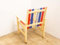 Colorful vintage wooden chair with unique slatted back, perfect for casual home or outdoor spaces.