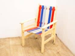 Vibrant red, white, and blue wooden chair, perfect for outdoor patio or garden use.