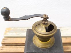Vintage brass and wood coffee grinder showcasing classic craftsmanship and timeless design.