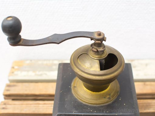 Vintage brass and wood coffee grinder showcasing classic craftsmanship and timeless design.
