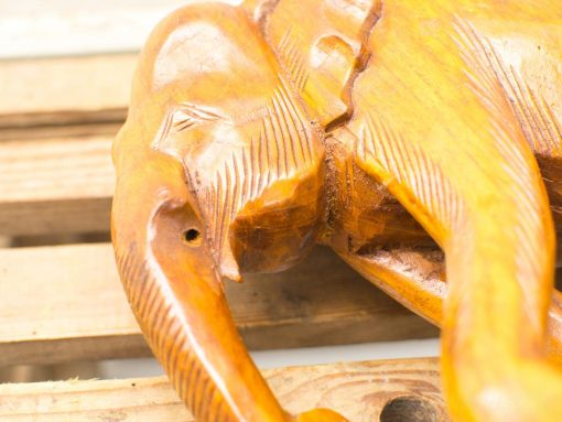 Intricately carved wooden elephant figurine symbolizing good luck and craftsmanship.