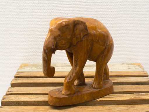 Handcrafted wooden elephant sculpture with intricate details and warm finish, perfect for any decor.