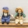 Charming vintage dolls in blue and green, perfect for collectors or playful companions.