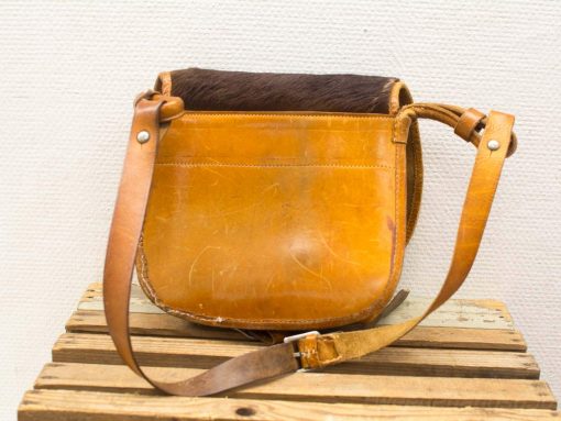 Vintage leather shoulder bag with fur accent, perfect for stylish, practical everyday use.