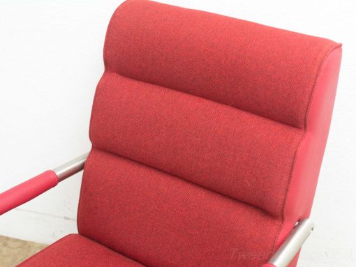 Vibrant red vintage chair with stylish metallic accents, perfect for modern interiors.